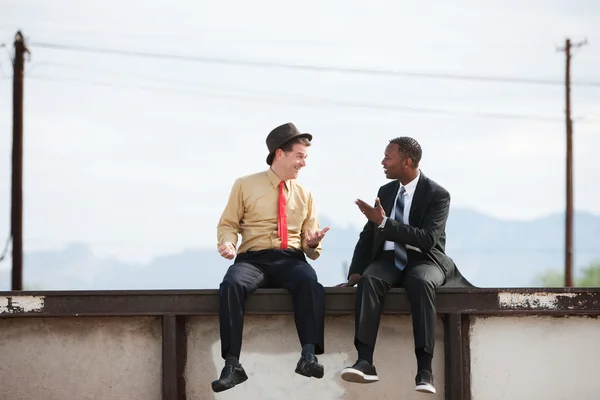 Talking and Sitting on a Wall — Stock Photo, Image