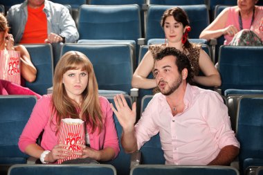 Man Talks to Woman in Theater clipart