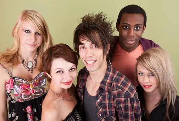 Five smiling urban teens in front of green wall. — Stock Photo, Image