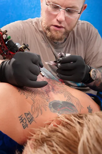 Tattoo kunstenaar en klant — Stockfoto