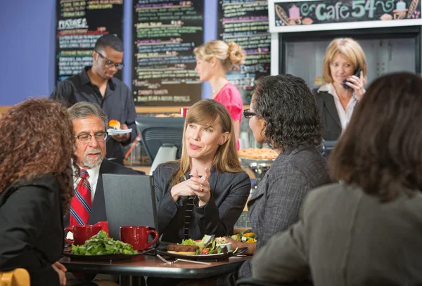 Smiling Executive Eating with Coworkers — Stock Photo, Image