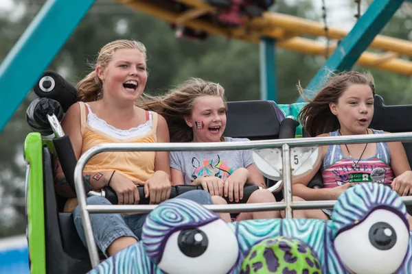 Girls on carnival ride at state fair — Stock Photo, Image