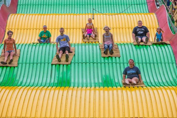 Kids on carnival slide at state fair — Stock Photo, Image