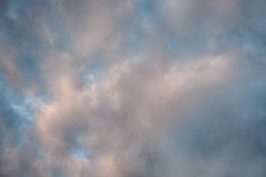 dramatic cirrus, feathery clouds against bright blue cloudy sky in the evening