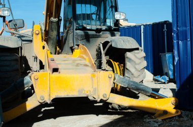 Telehandler awaiting new tyre to be fitted after accident on construction site when tyre bursted under load