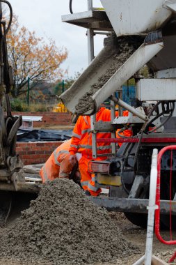Ready mix semi-dry concrete delivered on construction site and offloaded from concrete vagon on the ground