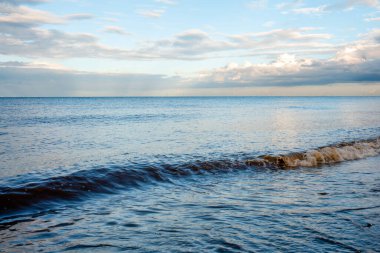 Kumsal, deniz ve bulutlu mavi gökyüzü güneşli bir günde İngiltere 'de