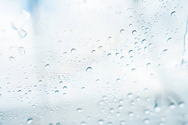 Water droplets on car glass after car wash. Rain drops on clear window