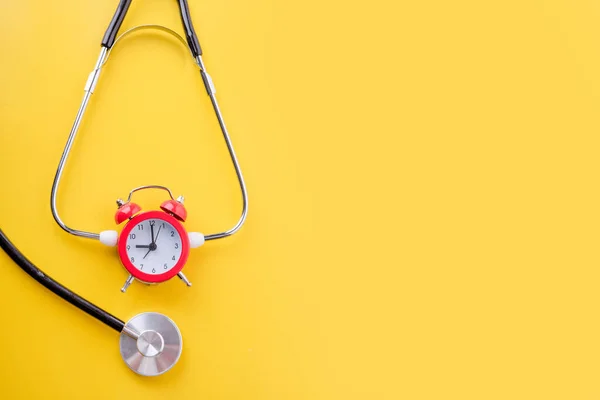 Stethoscope Alarm Clock Yellow Background Time Book Health Check —  Fotos de Stock