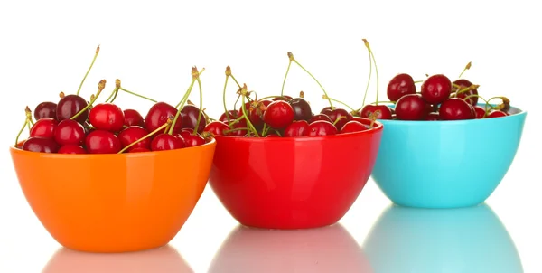Cherry in colorful bowls isolated on white — Stock Photo, Image