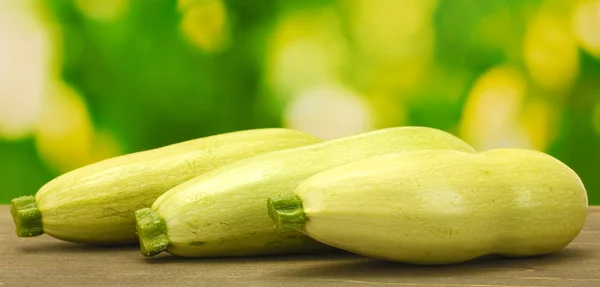 Squash on wooden table on green background close-up — Stock Photo, Image