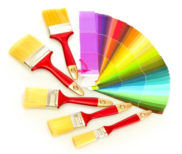 Paint brushes and bright palette of colors isolated on white — Stock Photo, Image