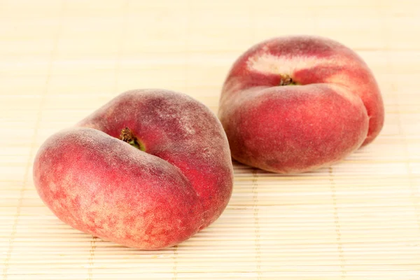 Ripe fig peaches on bamboo mat — Stock Photo, Image