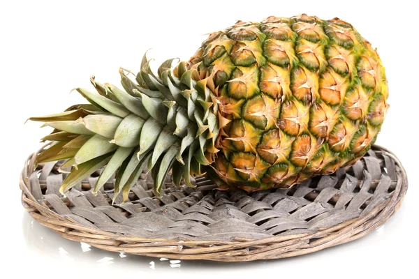 Pineapple on wicker mat isolated on white — Stock Photo, Image