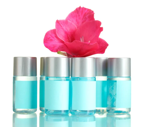 Cosmetic bottles and flower, isolated on white — Stock Photo, Image