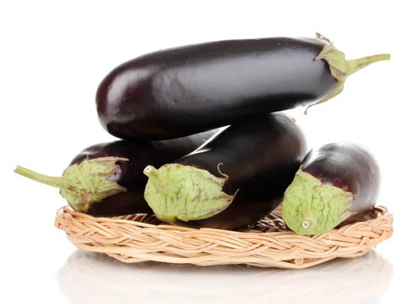 Fresh eggplants on wicker mat isolated on white — Stock Photo, Image