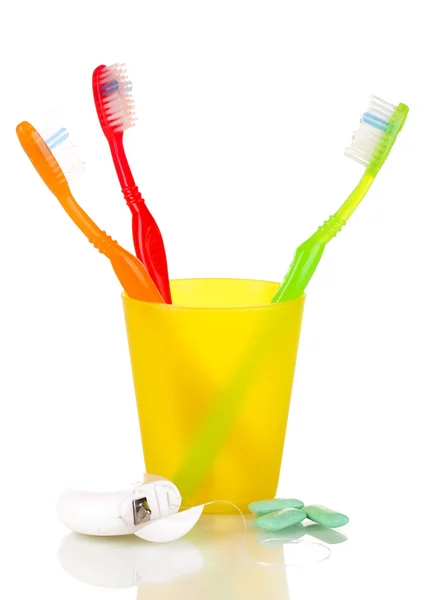 Toothbrushes, chewing gum and dental floss isolated on white — Stock Photo, Image