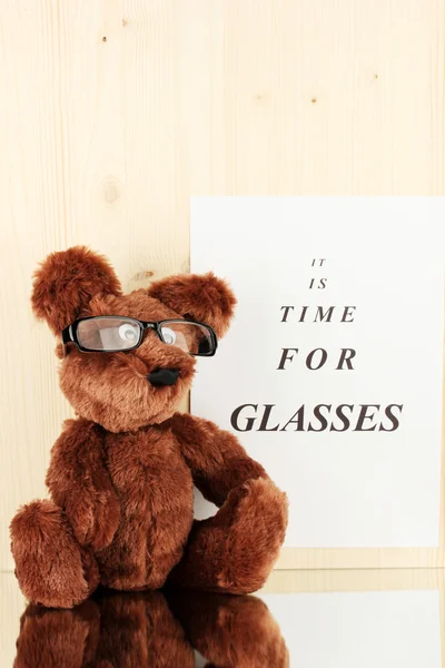 Eyesight test chart with glasses and with toy on wooden background close-up — Stock Photo, Image