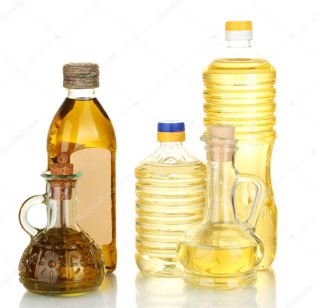 Olive and sunflower oil in the bottles and small decanters isolated on whit