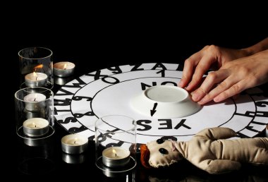Spiritualistic seance by candlelight close-up clipart