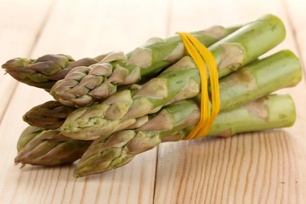 Useful asparagus close-up on wooden table on white background — Stock Photo, Image