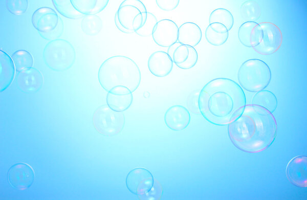 Soap bubbles on blue background
