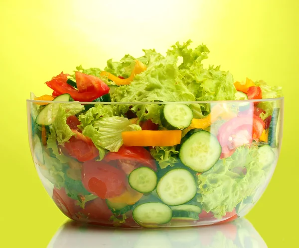 Φρέσκια σαλάτα λαχανικών σε διαφανές μπολ σε πράσινο φόντο — Φωτογραφία Αρχείου