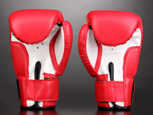 Rote Boxhandschuhe auf grauem Hintergrund — Stockfoto