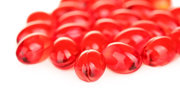 Pílulas vermelhas no fundo branco close-up — Fotografia de Stock