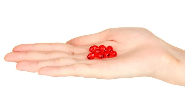 Woman's hand holding a red pill on white background close-up — Stock Photo, Image