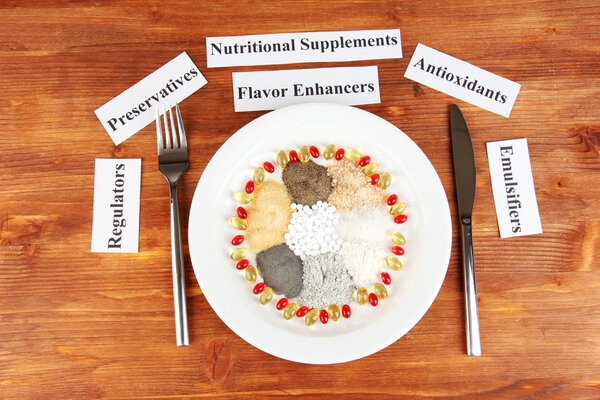 Nutritional supplements on wooden background close-up