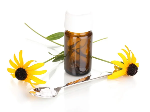 Medicine bottle with tablets and flowers isolated on white — Stock Photo, Image