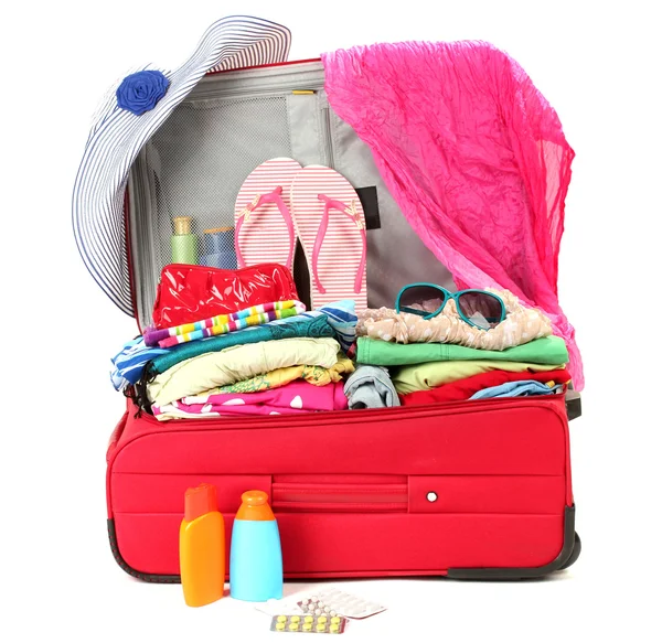 Kişisel eşyalar üzerinde beyaz izole kırmızı seyahat bavul — Stok fotoğraf