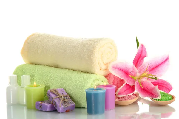 Towels with lily, aroma oil, candles, soap and sea salt isolated on white — Stock Photo, Image