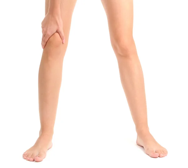 Frau mit schmerzenden Beinen, isoliert auf weißem Grund — Stockfoto