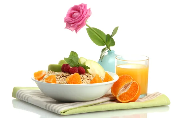 Tasty oatmeal with fruits and glass of juice, isolated on white — Stock Photo, Image