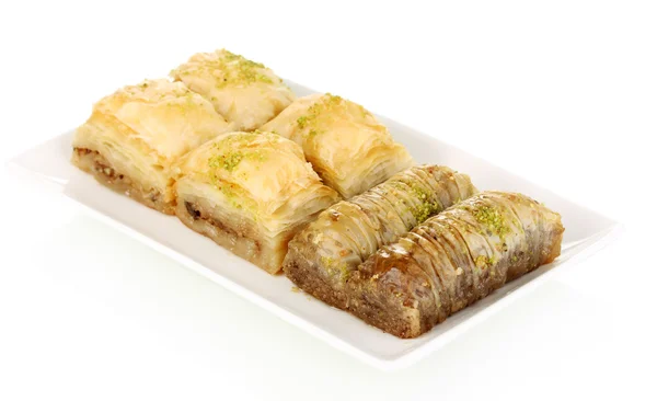 Sweet baklava on plate isolated on white — Stock Photo, Image