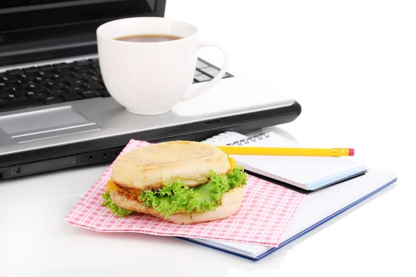 Eating at work place near laptop — Stock Photo, Image