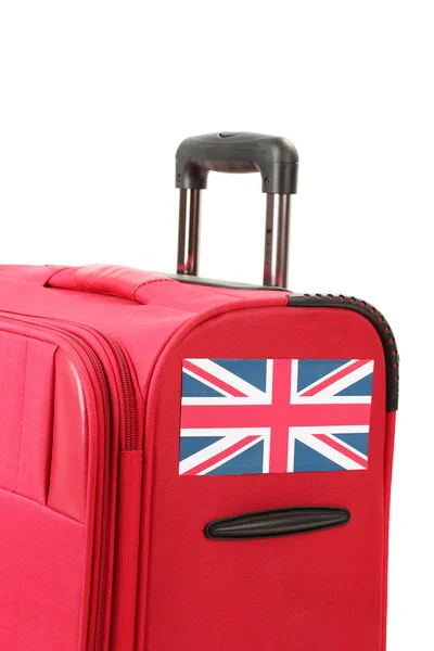 Red suitcase with sticker with flag of United Kingdom isolated on white — Stock Photo, Image