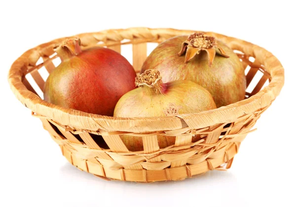 Unripe pomegranates in wicker basket isolated on white — Stock Photo, Image