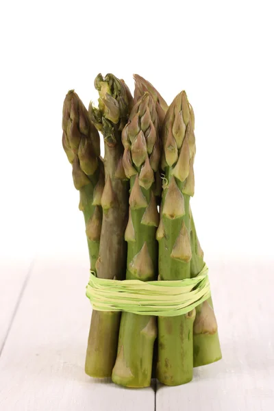 Useful asparagus on wooden table on white background — Stock Photo, Image