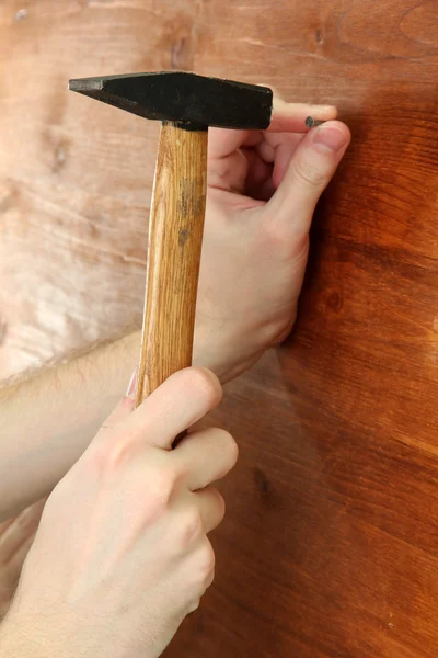 Man hands with nail and hammer — Stock Photo, Image