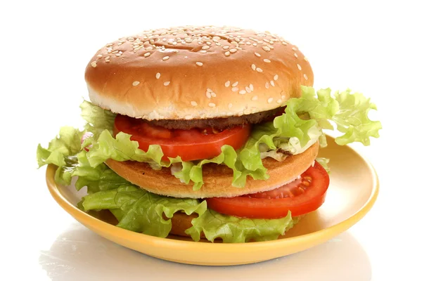 Big and tasty hamburger on plate isolated on white — Stock Photo, Image