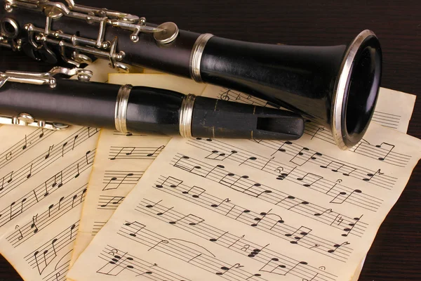 Musiknoter och klarinett på träbord — Stockfoto