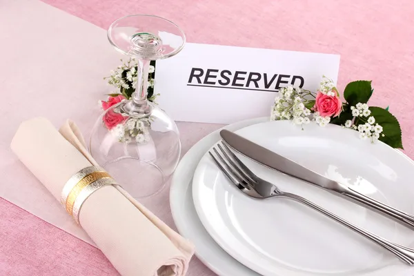 Table setting with reserved card in restaurant — Stock Photo, Image