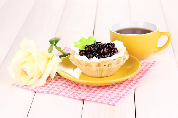 Zoete cake met kopje thee op houten achtergrond — Stockfoto