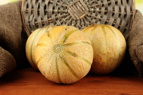 Sweet melon on wicker mat on sackcloth background close-up — Stock Photo, Image