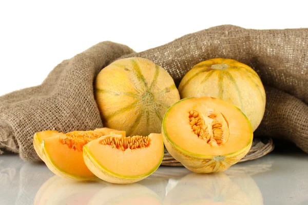 Cut melon on wicker mat on sackcloth background close up — Stock Photo, Image