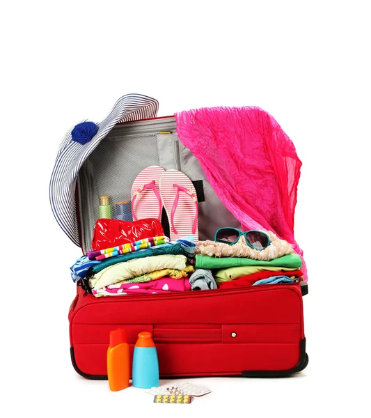 Red travel suitcase with personal belongings isolated on white — Stock Photo, Image
