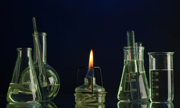 Spiritlamp and test-tubes on blue background — Stock Photo, Image